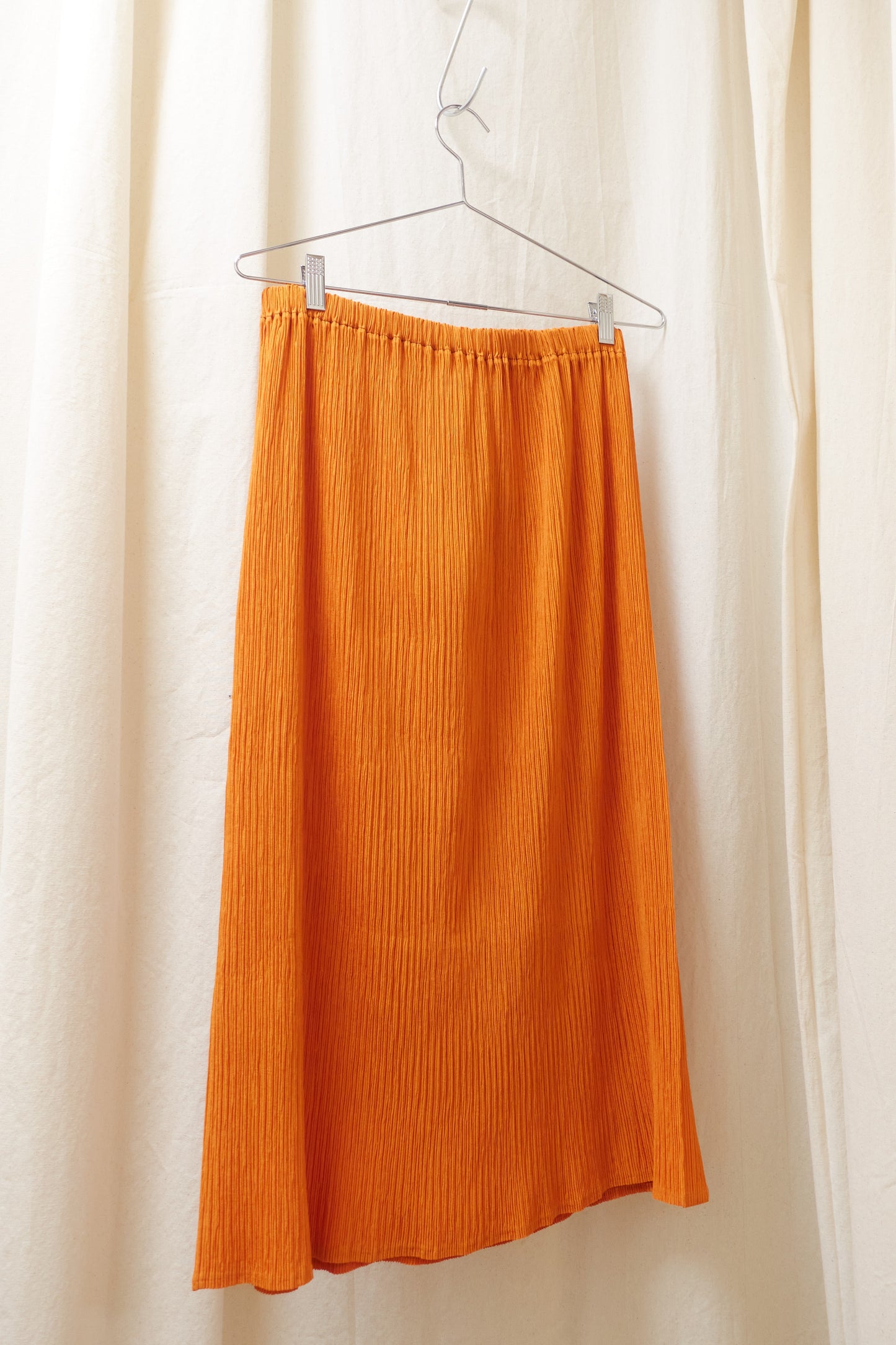 Issey Miyake orange pleated skirt