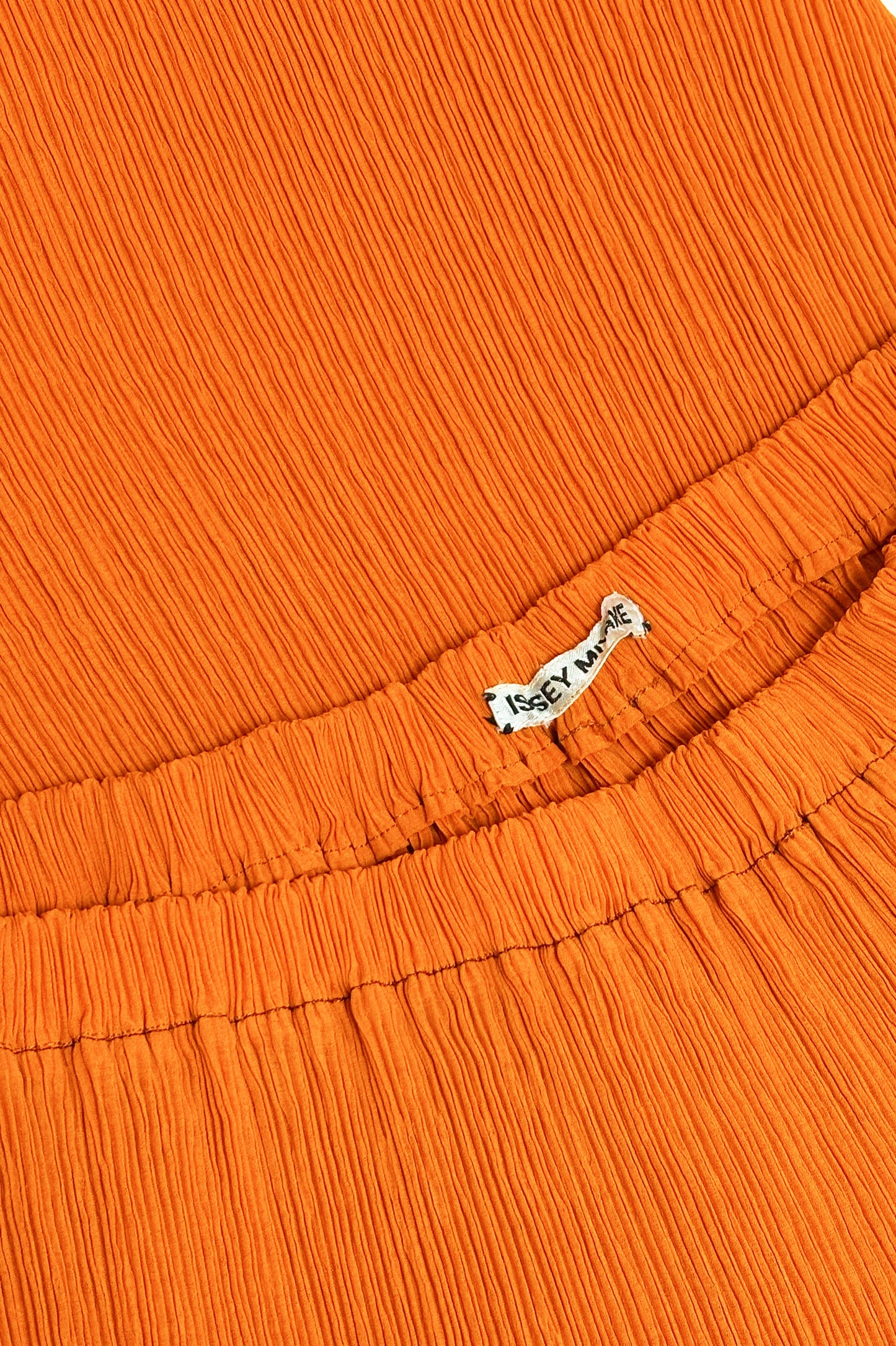 Issey Miyake orange pleated skirt
