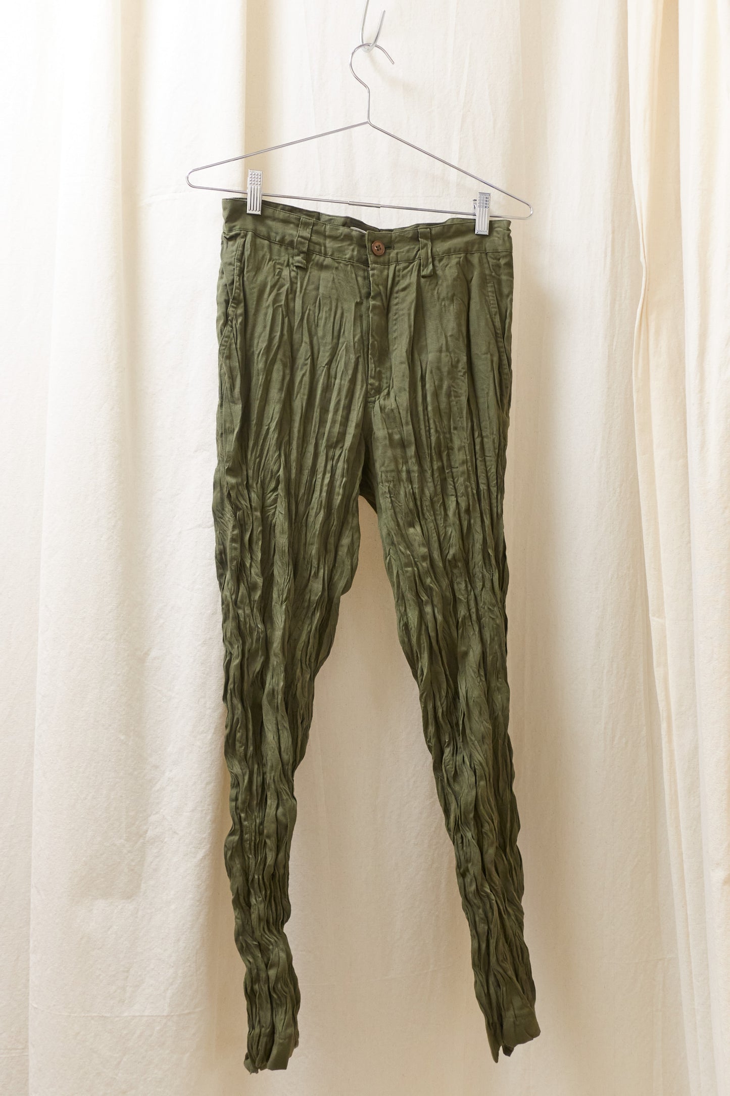 Issey Miyake green wrinkled trousers