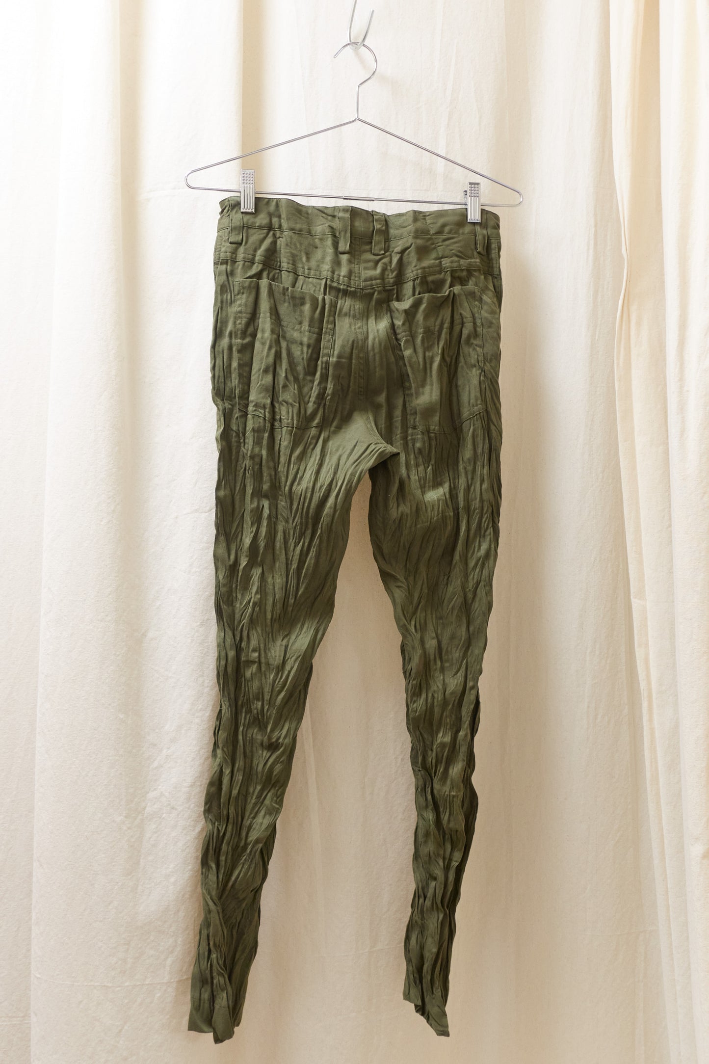Issey Miyake green wrinkled trousers