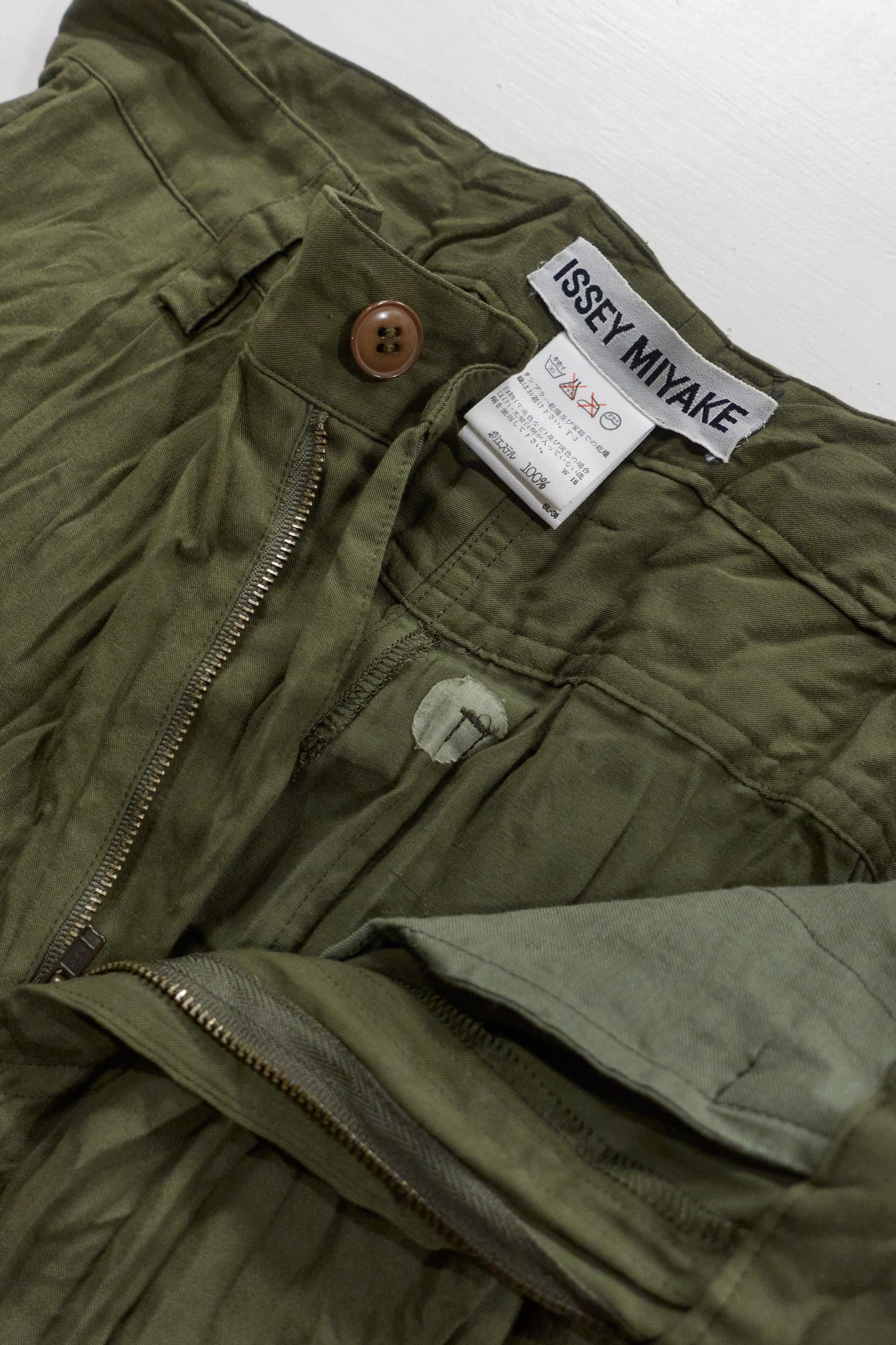 Issey Miyake green wrinkled trousers