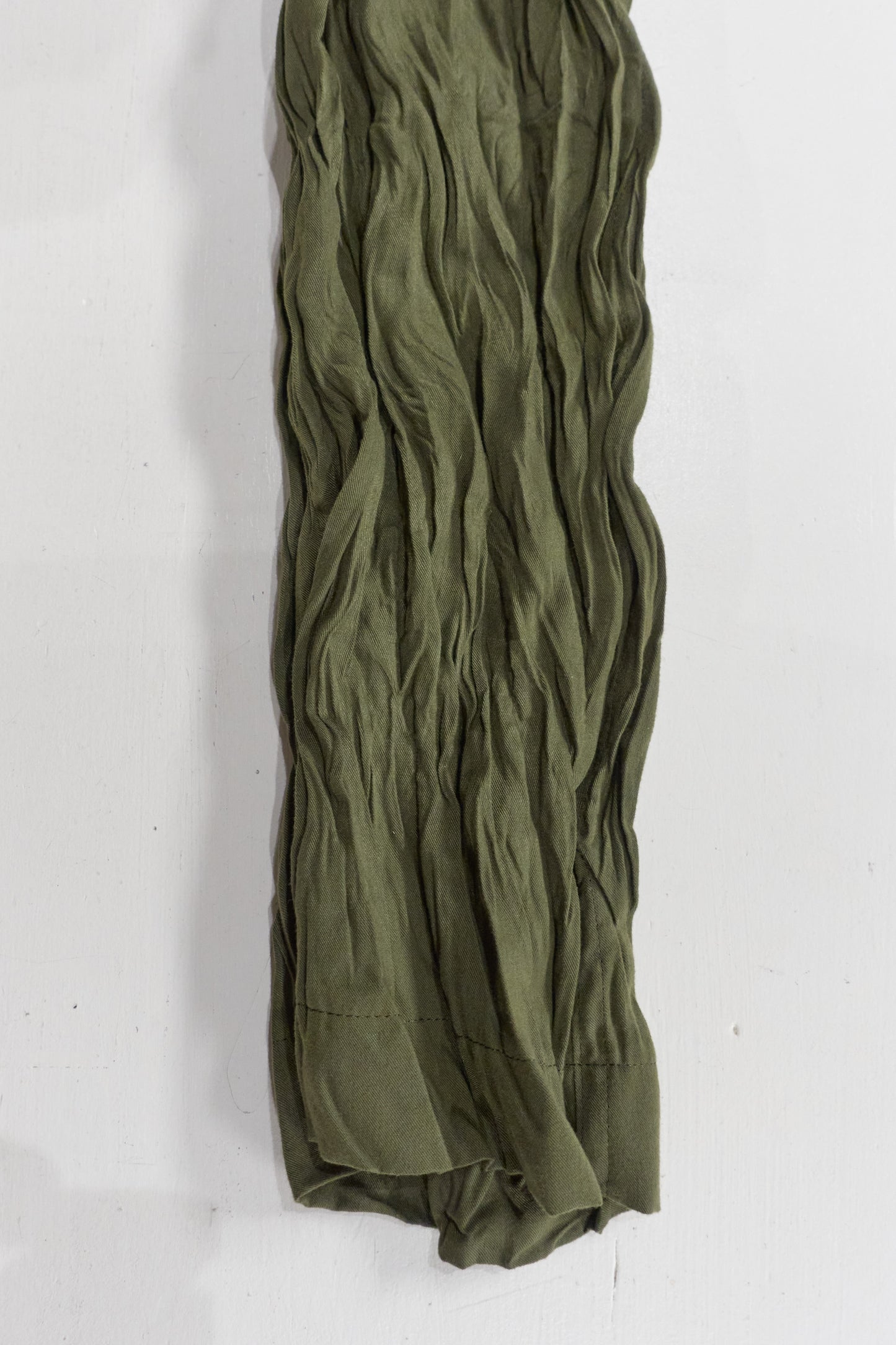 Issey Miyake green wrinkled trousers