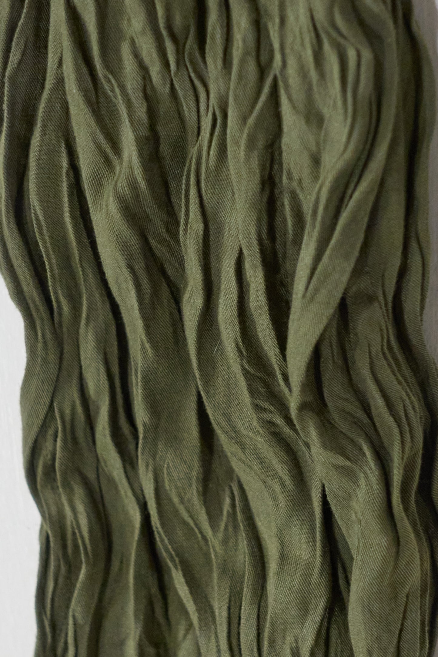 Issey Miyake green wrinkled trousers