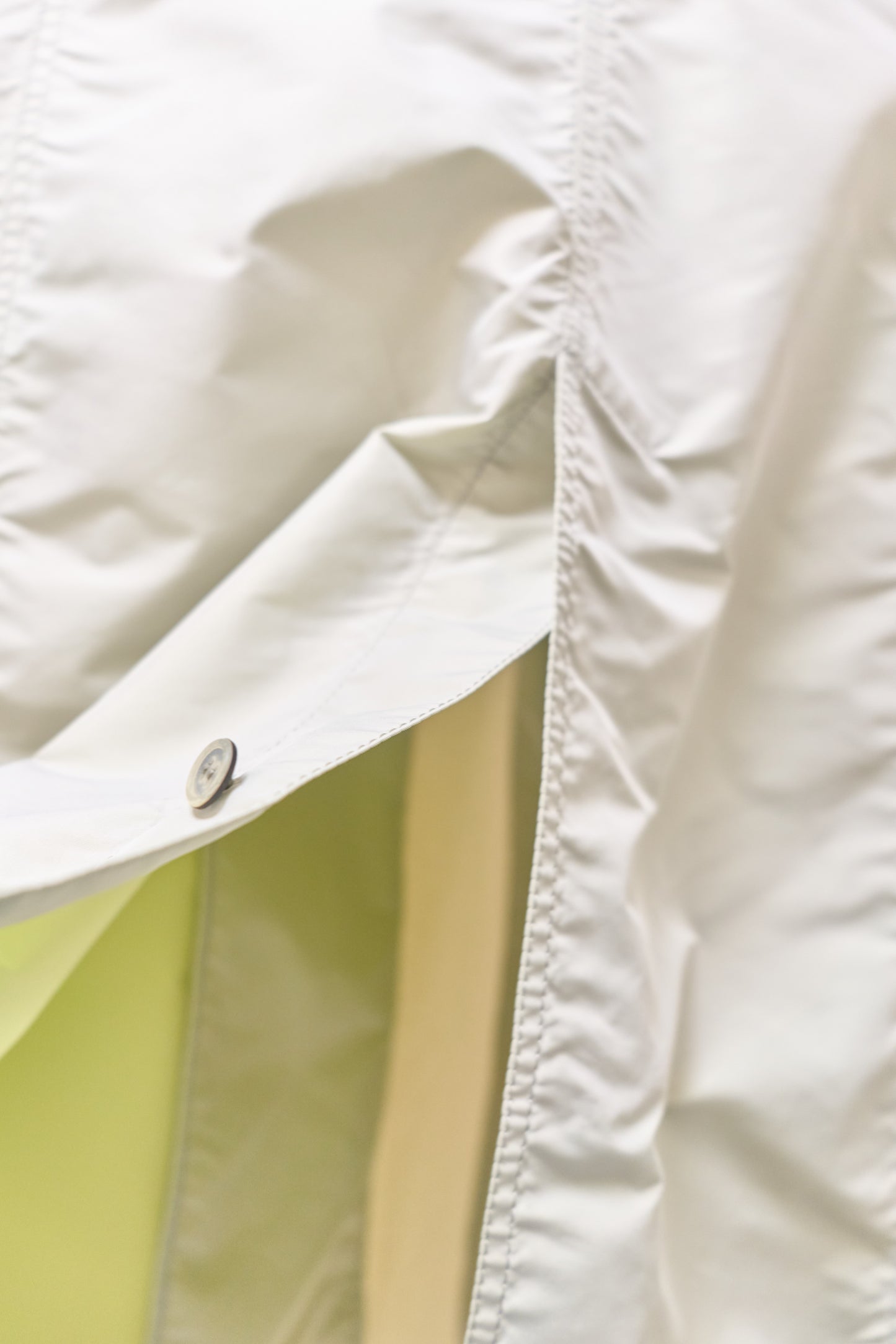 Issey Miyake sheeny trench coat with fluorescent yellow inner