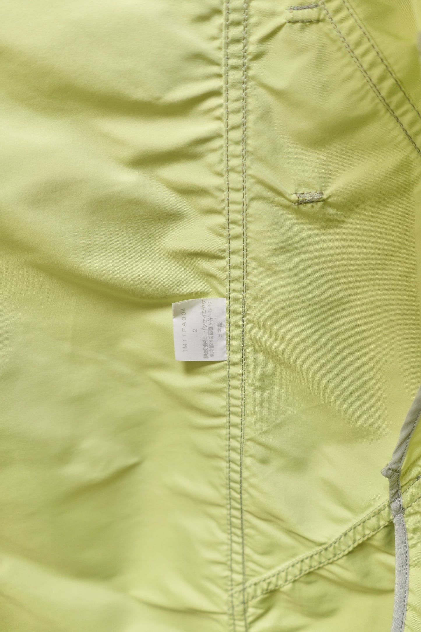 Issey Miyake sheeny trench coat with fluorescent yellow inner