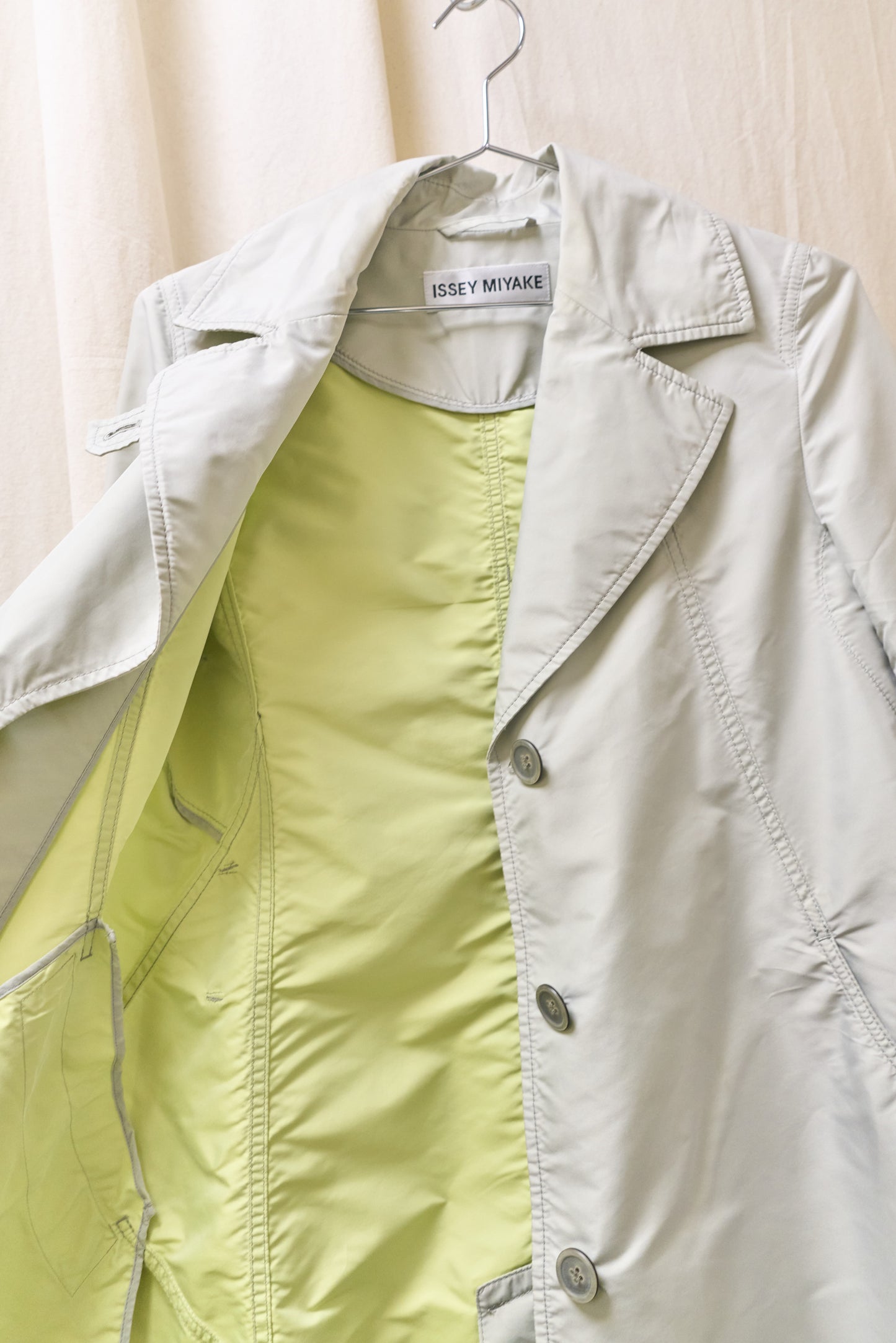 Issey Miyake sheeny trench coat with fluorescent yellow inner